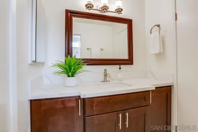 an aerial view of a city with lots of residential buildings and ocean view in back