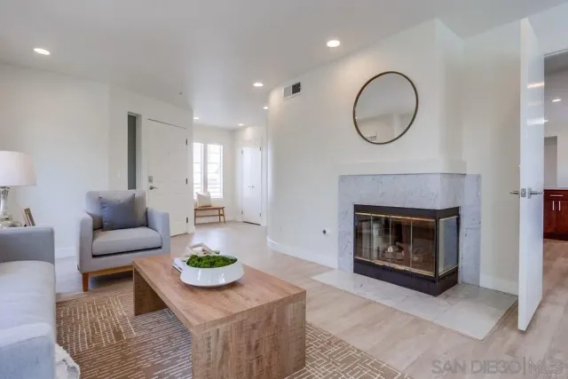 a living room with furniture a clock and a fireplace