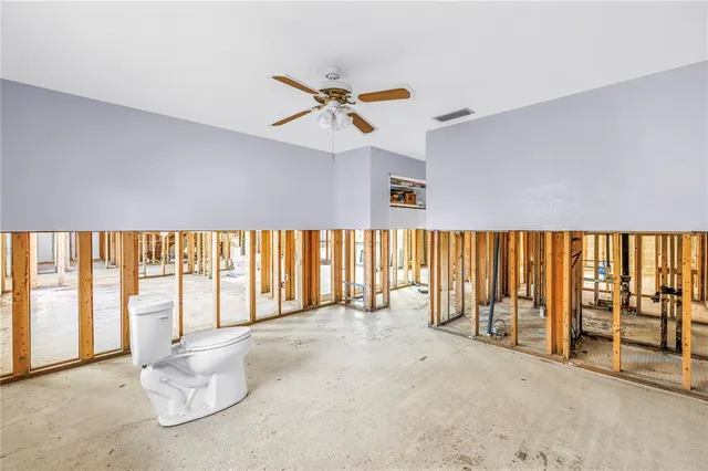 an empty room with windows and city view