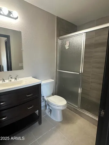 a bathroom with a sink mirror vanity and toilet