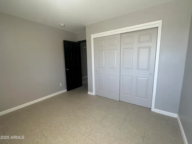 an empty room with closet area
