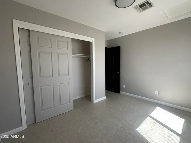 an empty room with ceiling fan