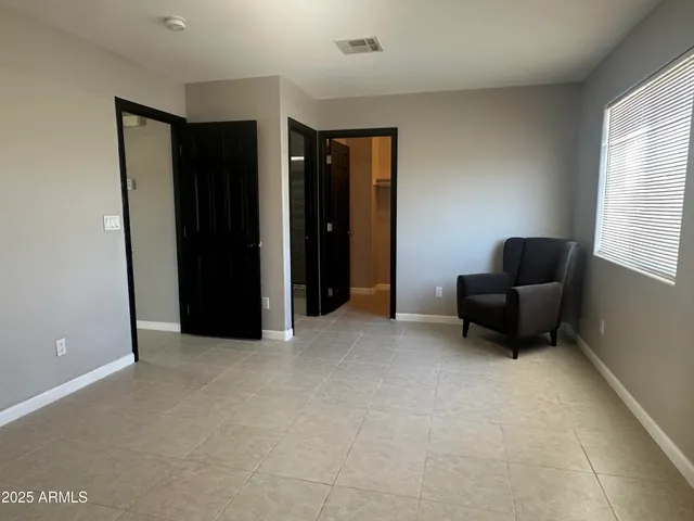 a living room with furniture and a bed