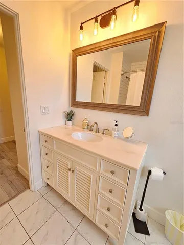a spacious bathroom with a double vanity sink and a mirror