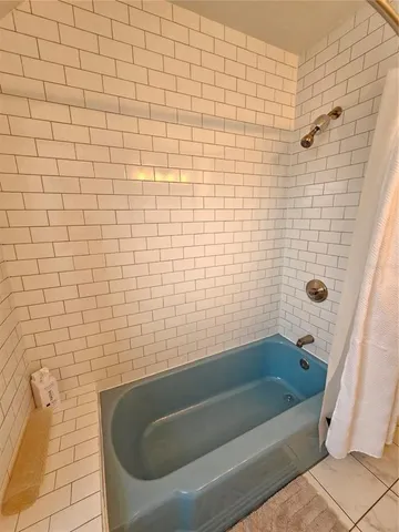 a bathroom with a tub and a shower
