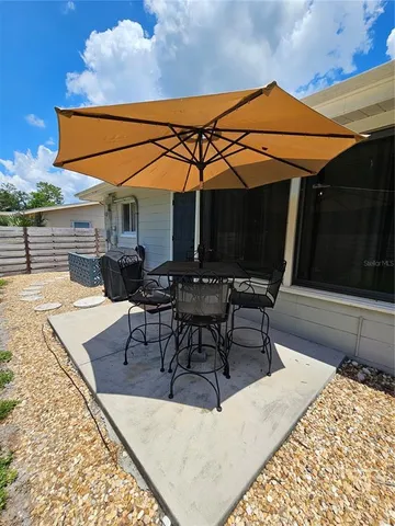 a outdoor space with the couches and dining table