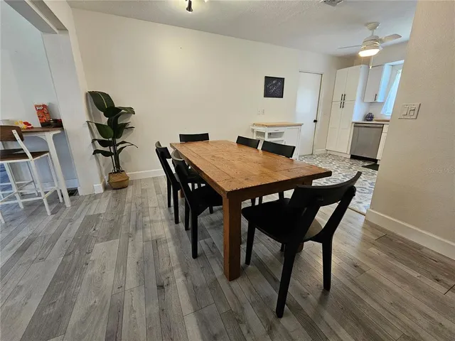a view of a dining room with furniture and wooden floor