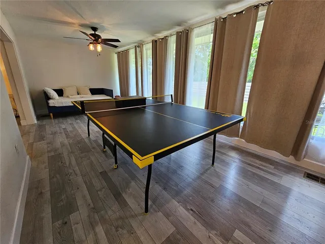 a view of a room with wooden floor and windows