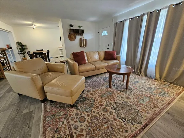 a living room with furniture and a rug