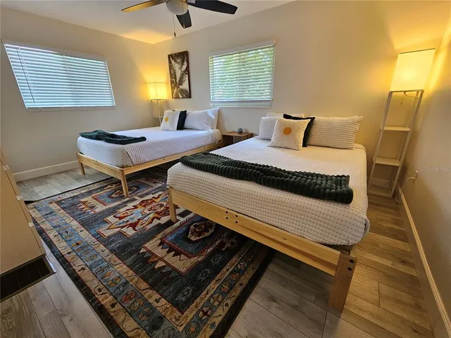 a bedroom with two beds and a window