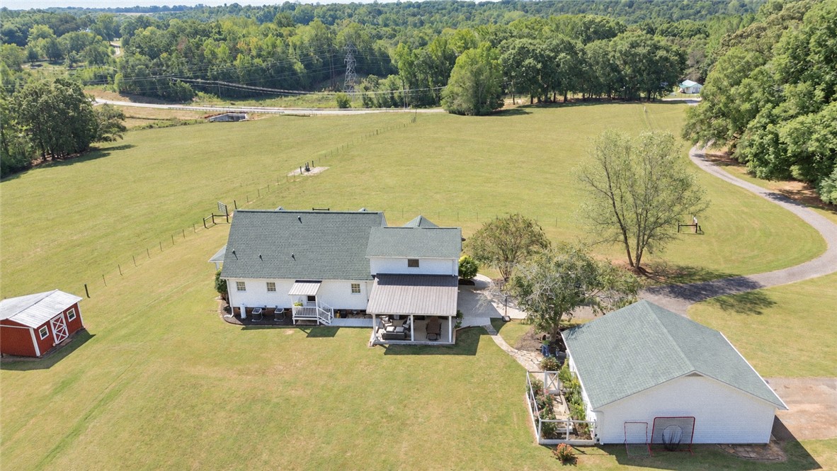 2420 Rainey Road Starr, SC 29684 - Photo 36 of 36 Green pastures roll gently behind this multi-structure country property framed by mature trees.