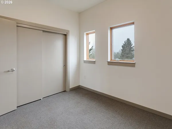 a view of a dining room with furniture and a window
