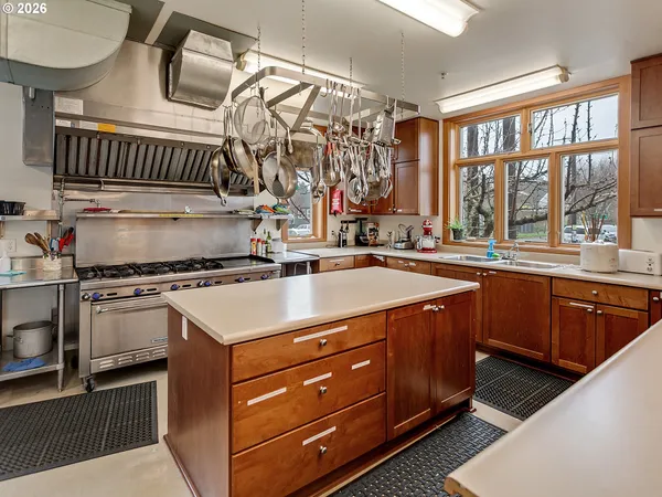 a living room with furniture a bookshelf and a window