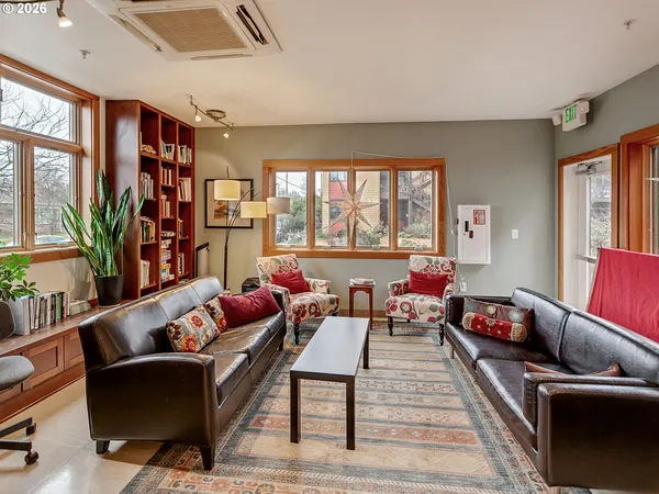 a dining room with furniture and a window