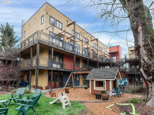 a front view of a residential apartment building with a yard