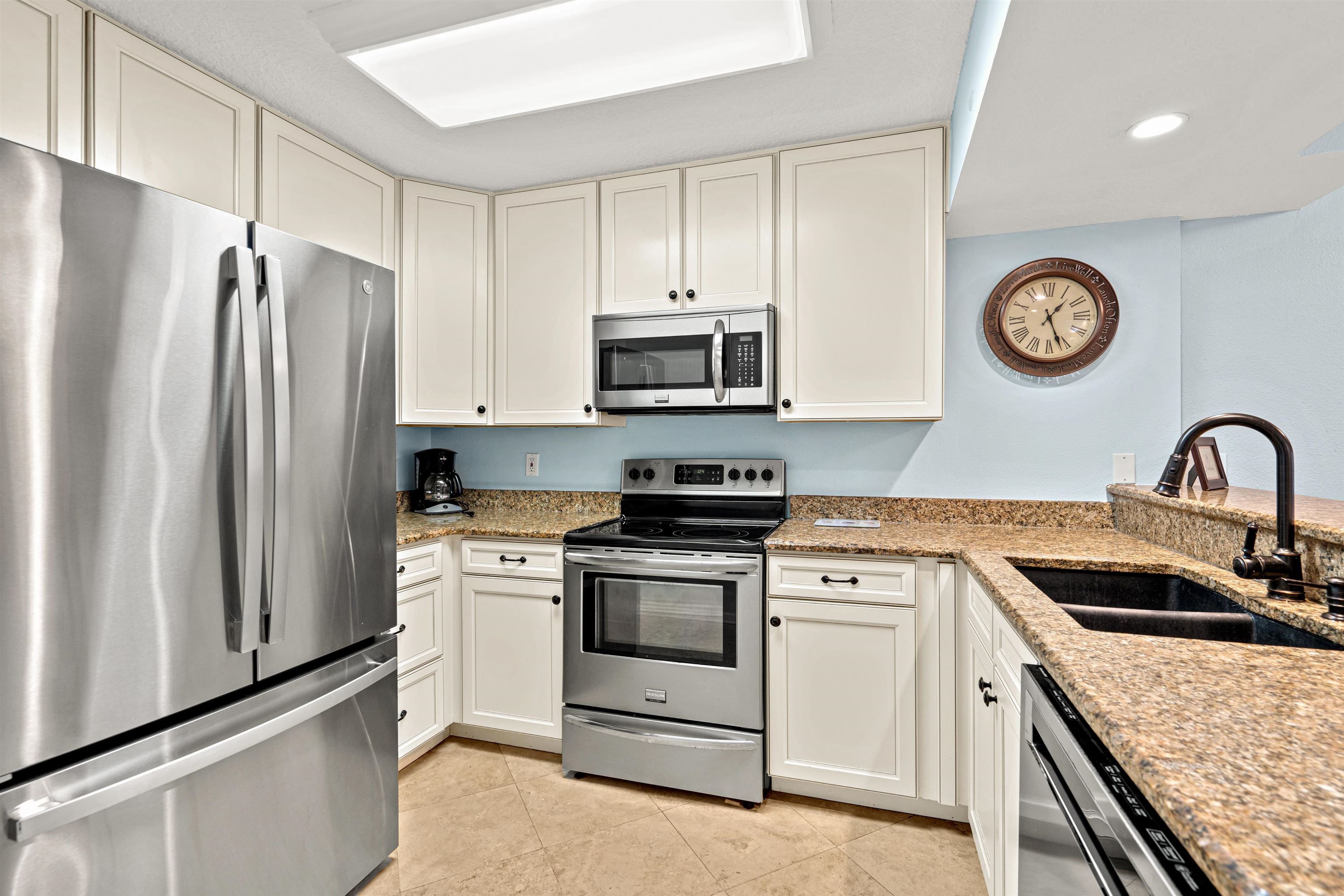 1 Ocean Trace Road, Unit 232 St. Augustine, FL 32080 - Photo 4 of 49 a kitchen with granite countertop white cabinets and stainless steel appliances