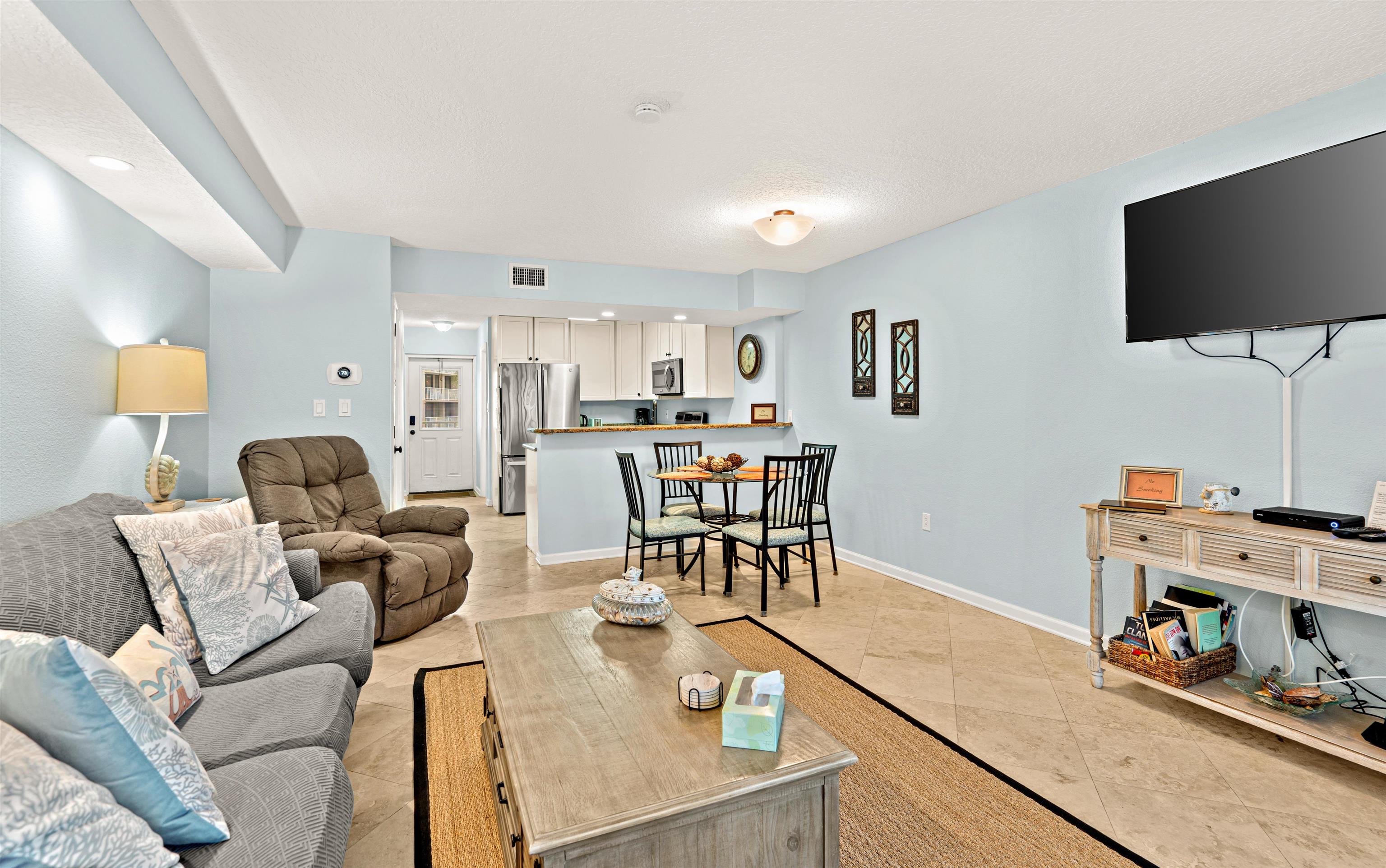 1 Ocean Trace Road, Unit 232 St. Augustine, FL 32080 - Photo 10 of 49 a living room with furniture and a flat screen tv
