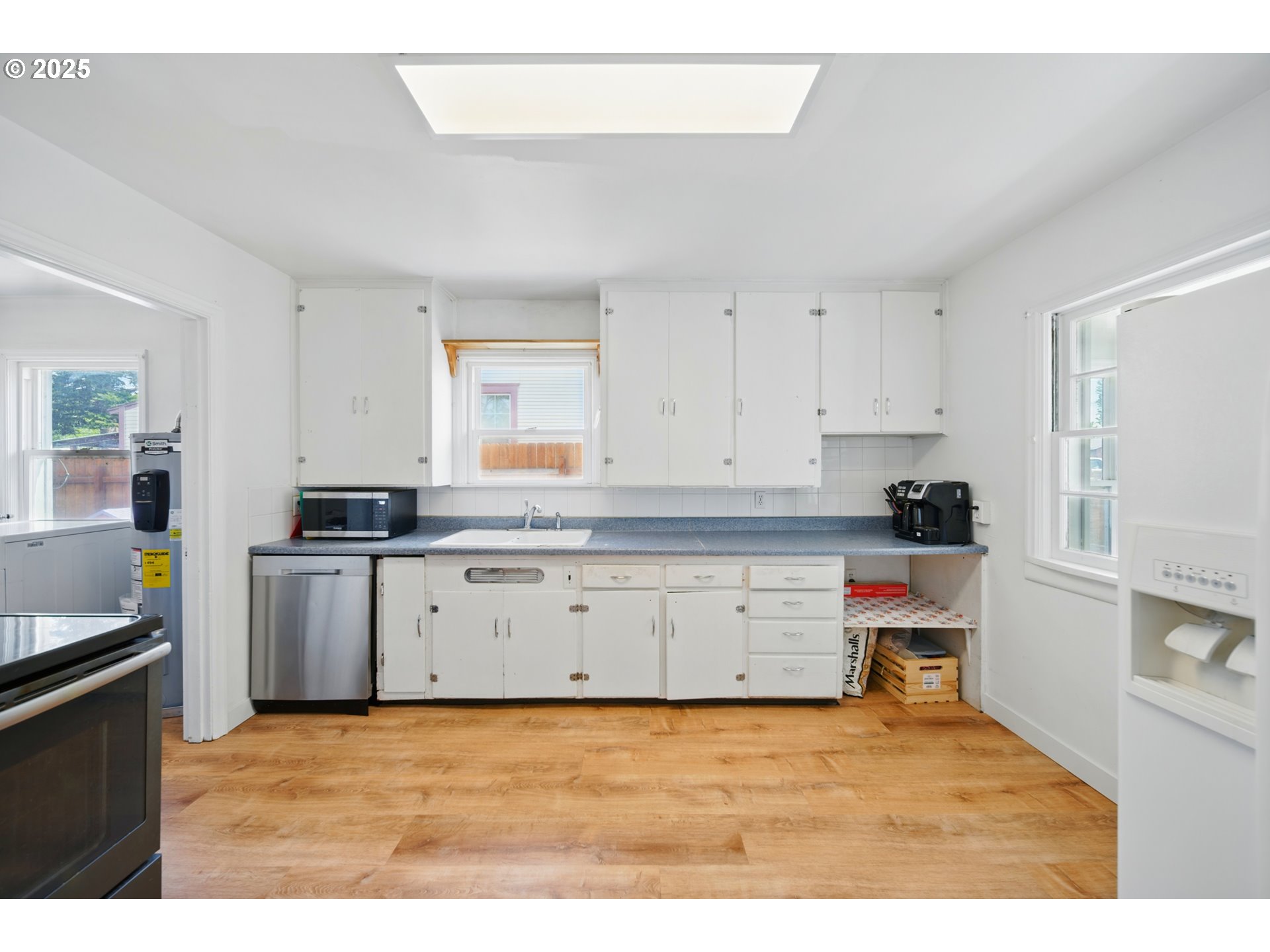 1317 Chestnut Street Milton Freewater, OR 97862 - Photo 5 of 23 a kitchen with granite countertop a stove a sink a refrigerator and white cabinets