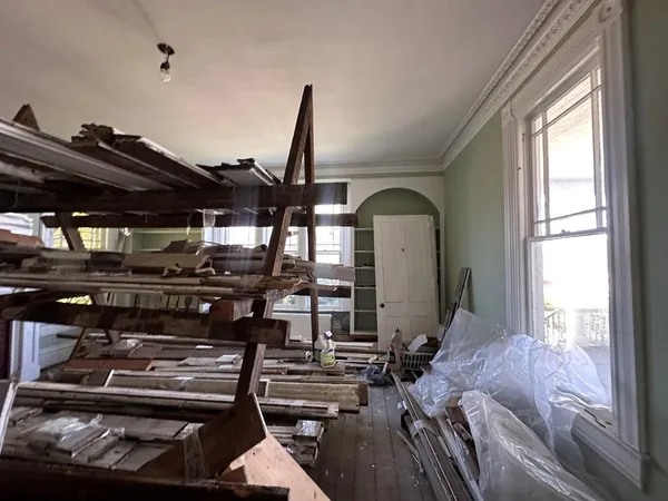 a living room with chairs and a window
