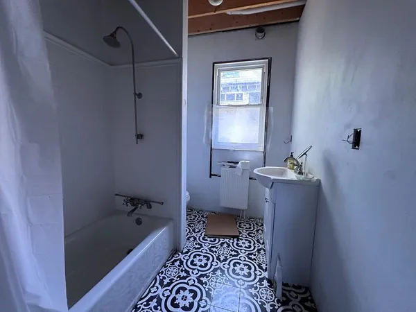 a bathroom with a bathtub a toilet and a shower