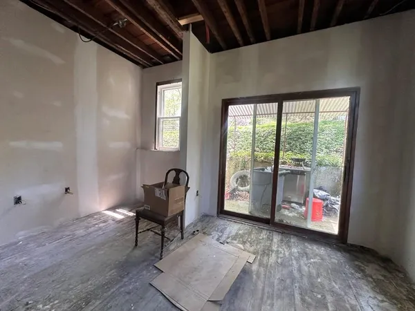 a living room with furniture and a floor to ceiling window