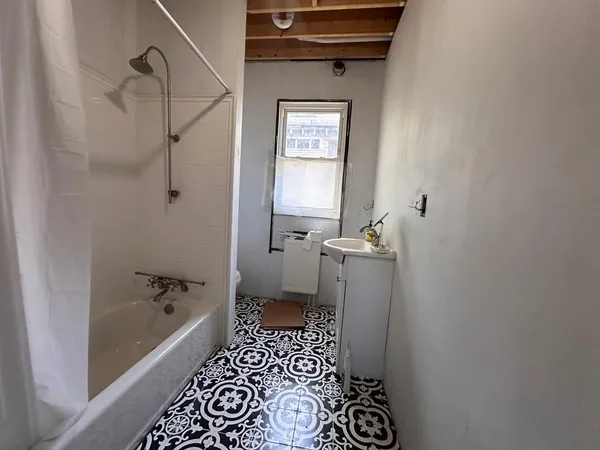 a bathroom with a bathtub and shower