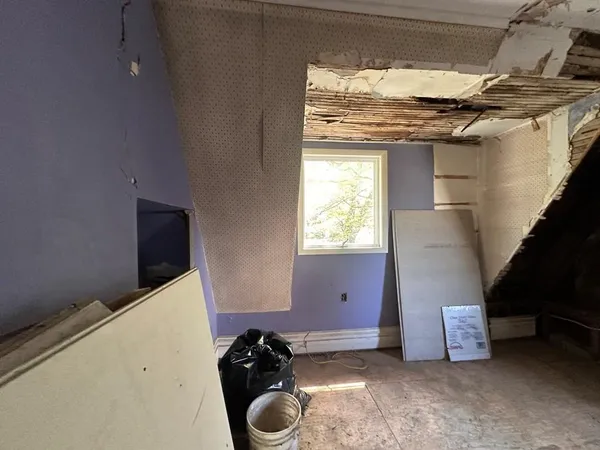 a room with water heater and a window