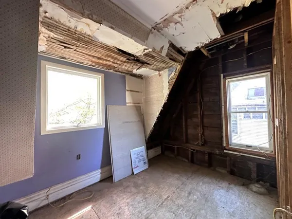 a view of a livingroom with an empty space and a window