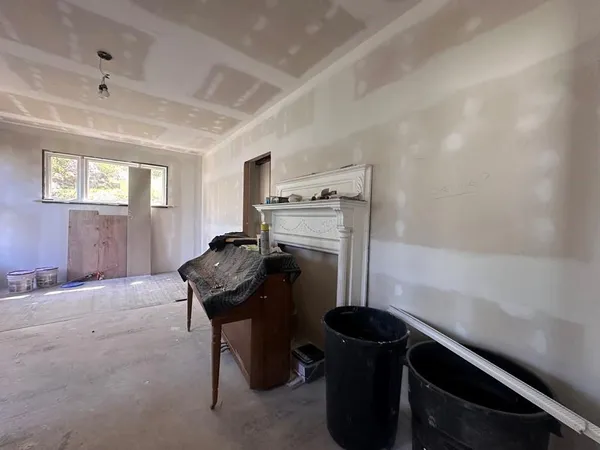 a kitchen with a stove and a wooden floor