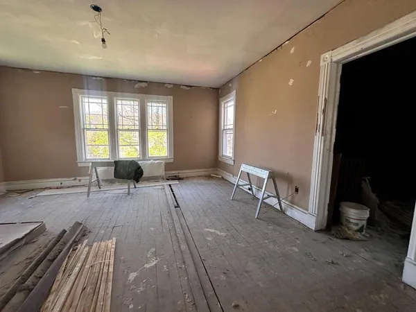 a spacious bedroom with a bed and a window