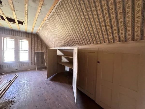 a view of a hallway with wooden walls and windows