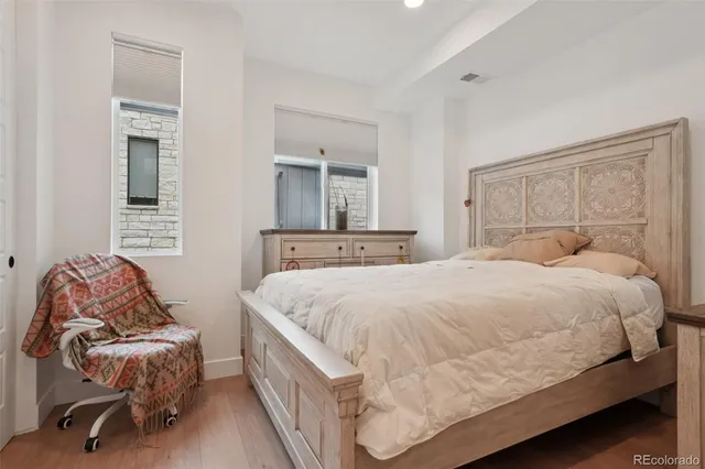 a bedroom with a bed and a chair