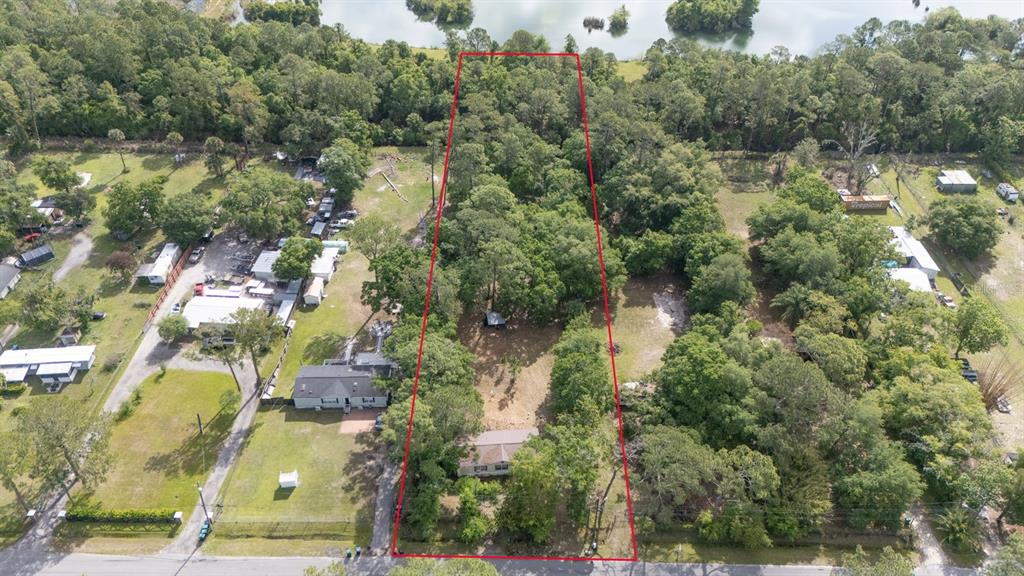 1263 St Nicholas Avenue Christmas, FL 32709 - Photo 3 of 5 an aerial view of residential houses with outdoor space and trees