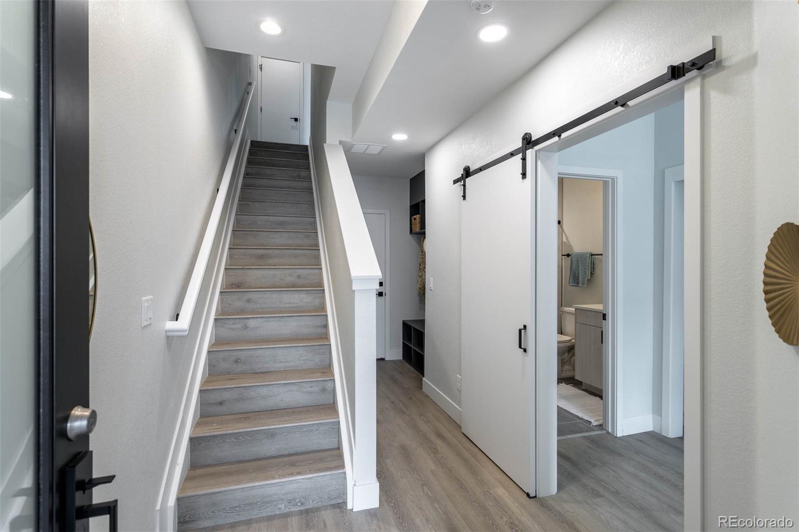 2360 West 49th Avenue Denver, CO 80221 - Photo 19 of 25 a view of a hallway with wooden floor and entryway