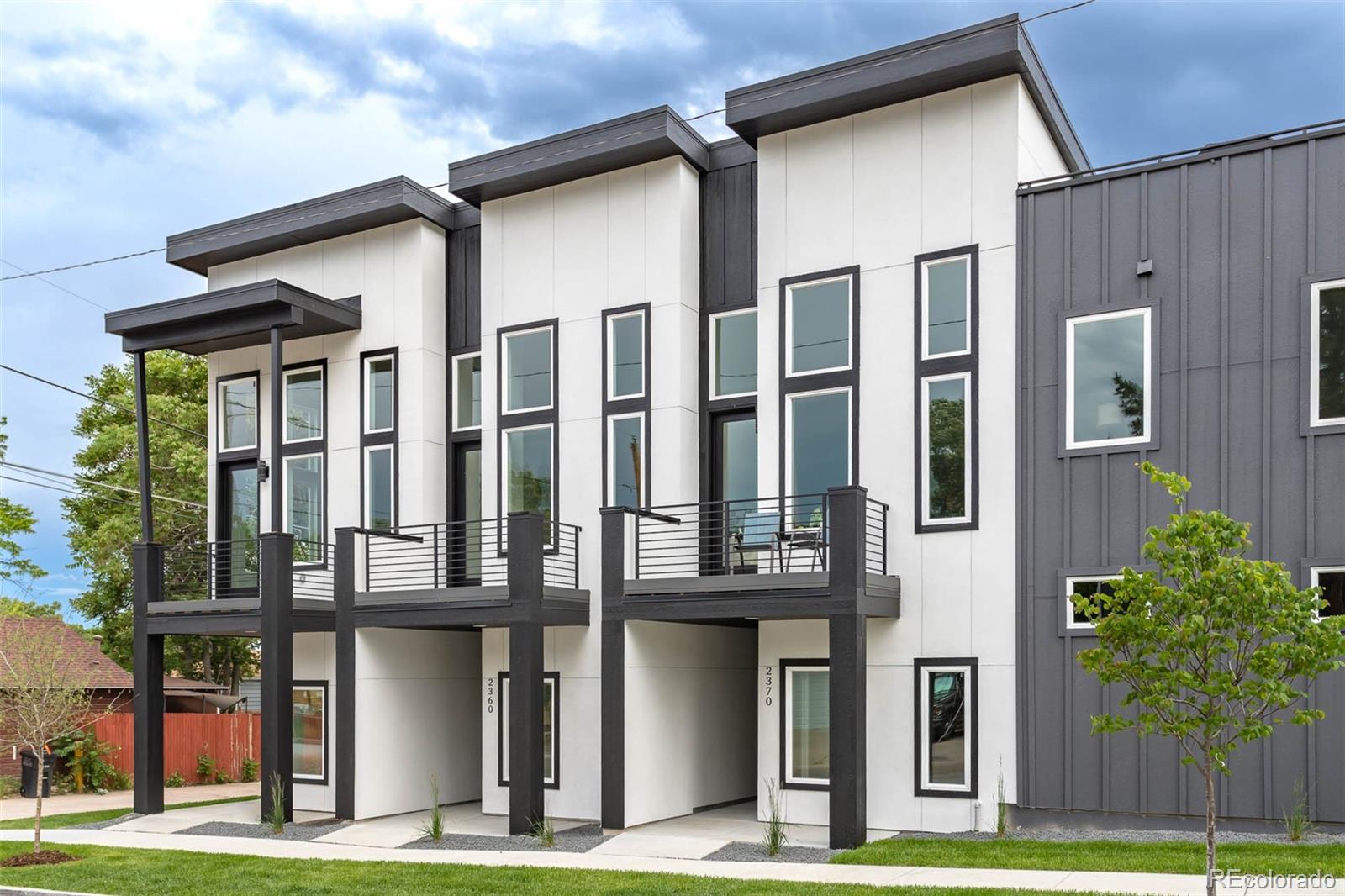 2360 West 49th Avenue Denver, CO 80221 - Photo 2 of 25 a front view of residential houses with yard