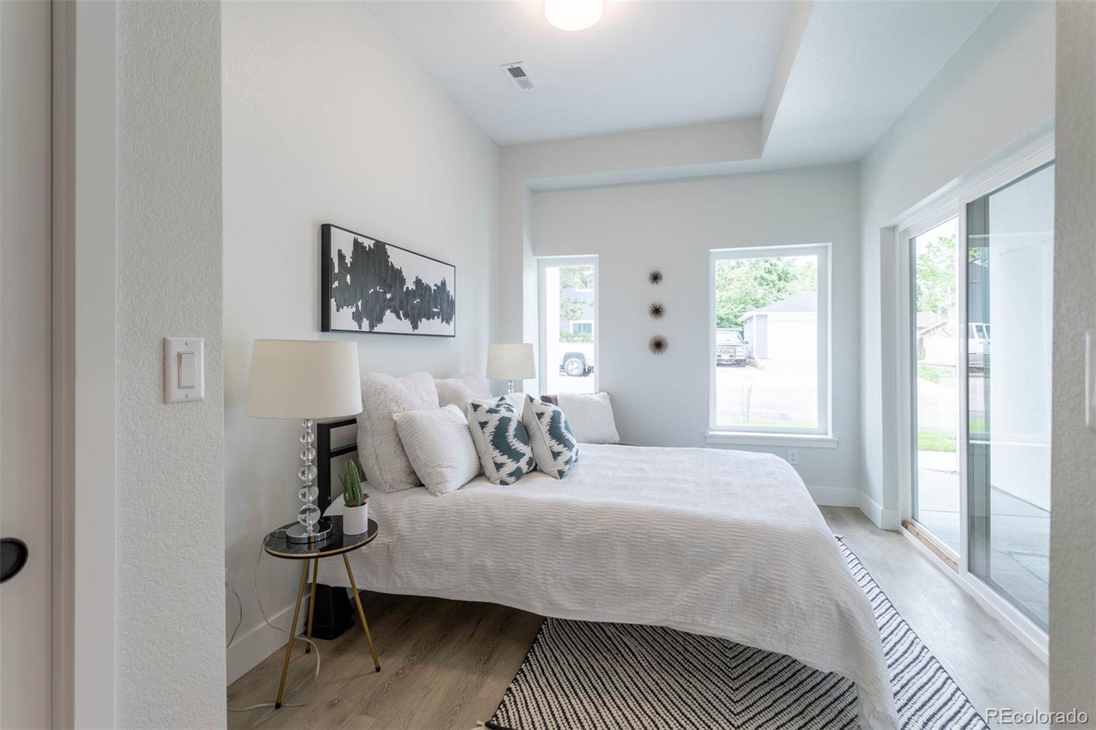 2360 West 49th Avenue Denver, CO 80221 - Photo 21 of 25 a bedroom with a bed and wooden floor