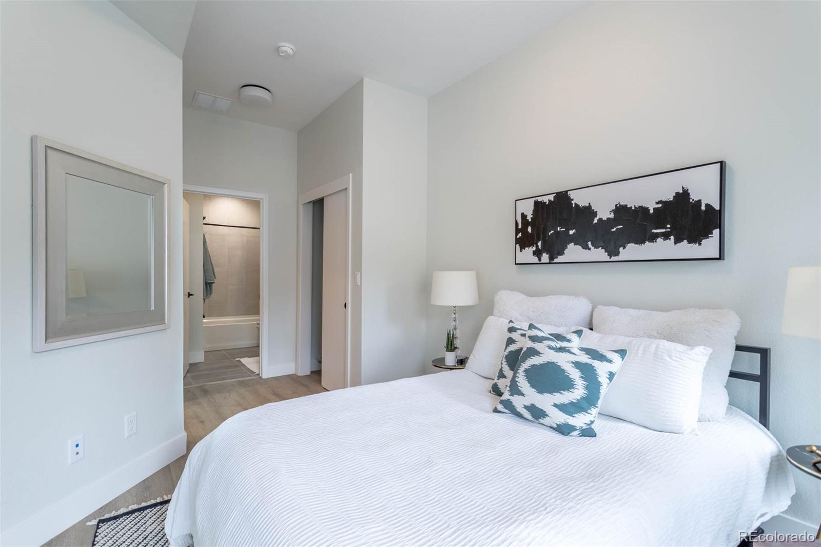 2360 West 49th Avenue Denver, CO 80221 - Photo 22 of 25 a bedroom with a bed and a painting on the wall