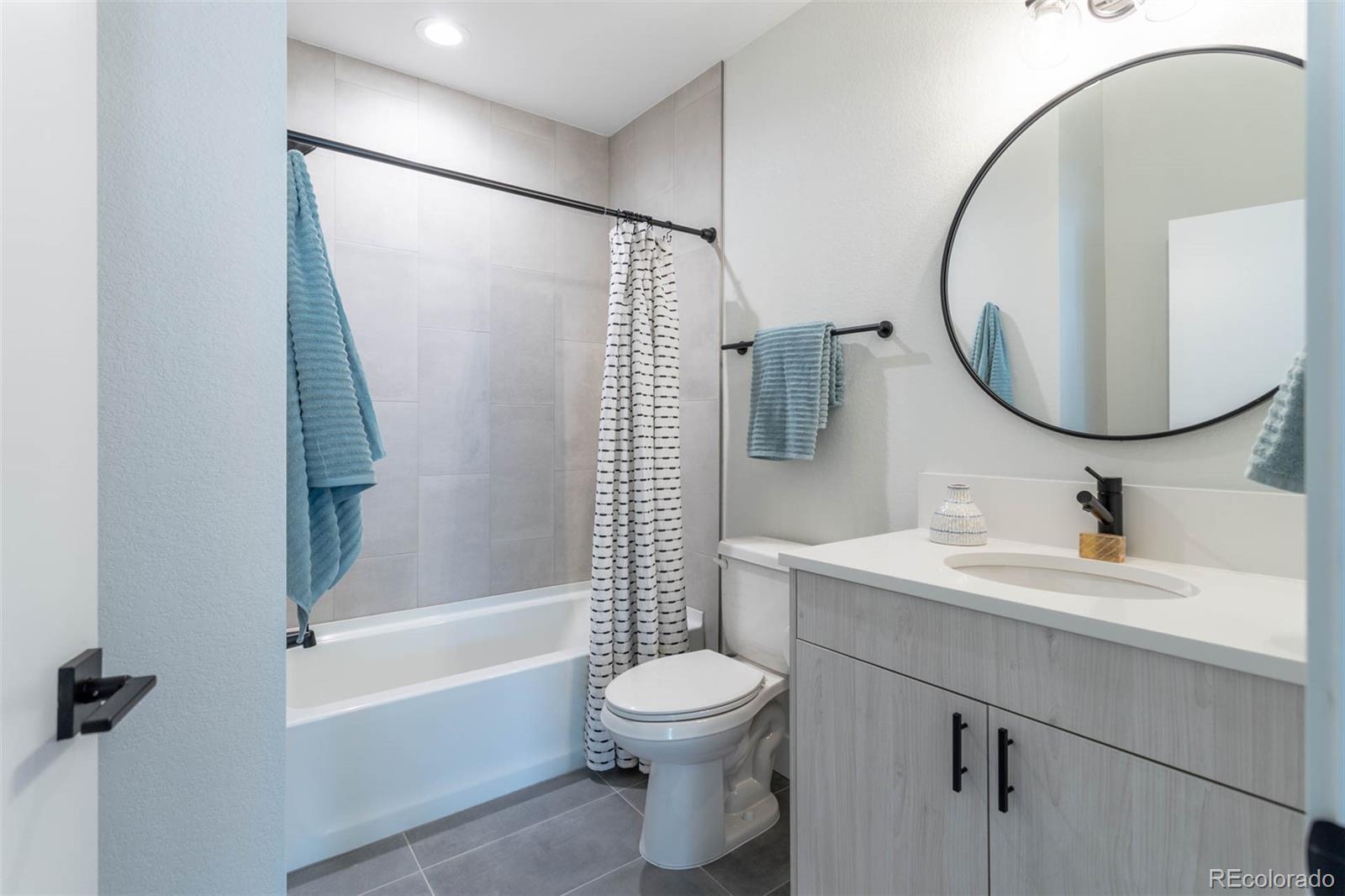 2360 West 49th Avenue Denver, CO 80221 - Photo 23 of 25 a bathroom with a toilet sink and a mirror