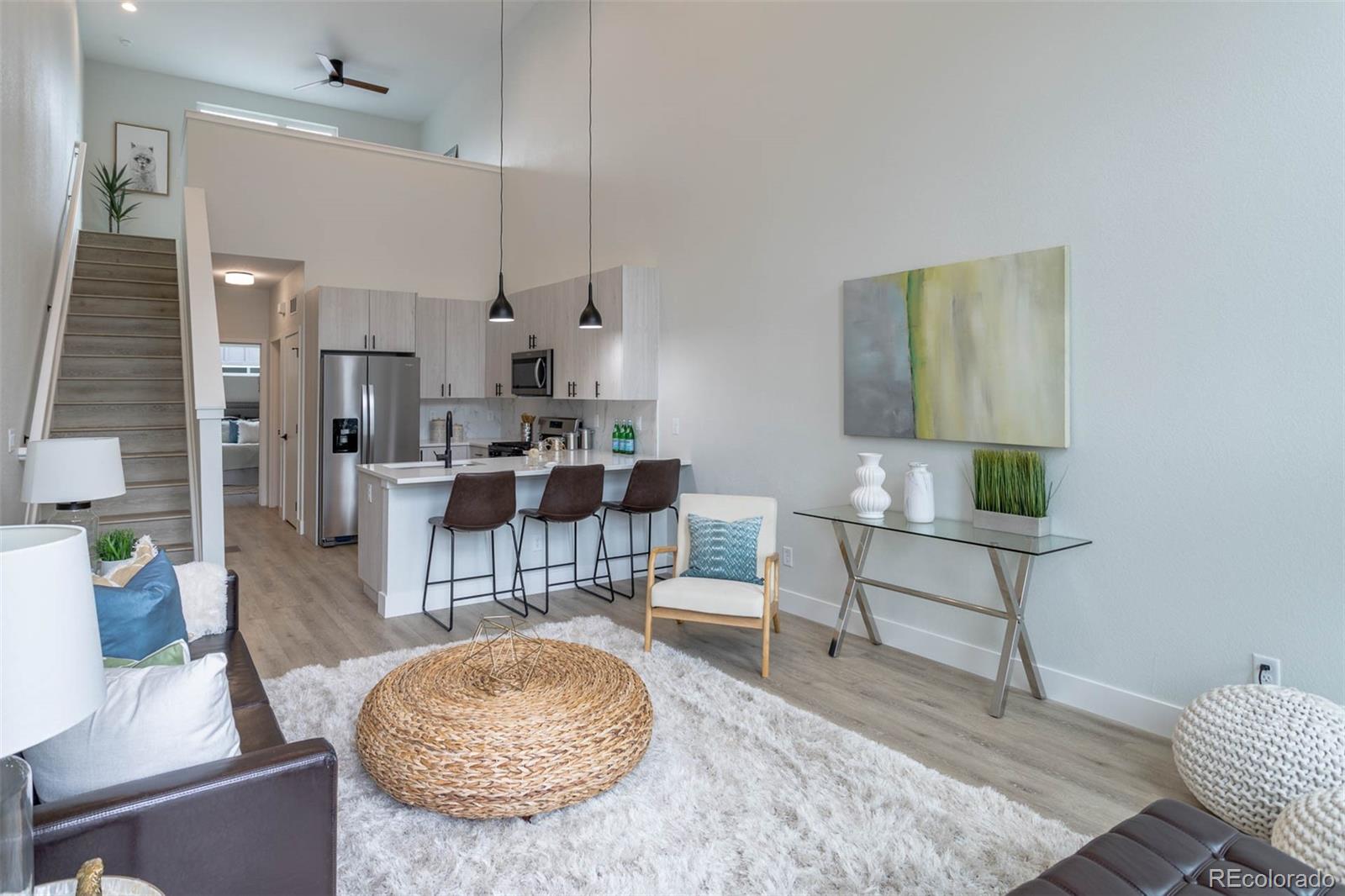 2360 West 49th Avenue Denver, CO 80221 - Photo 4 of 25 a living room with furniture a rug and a fireplace