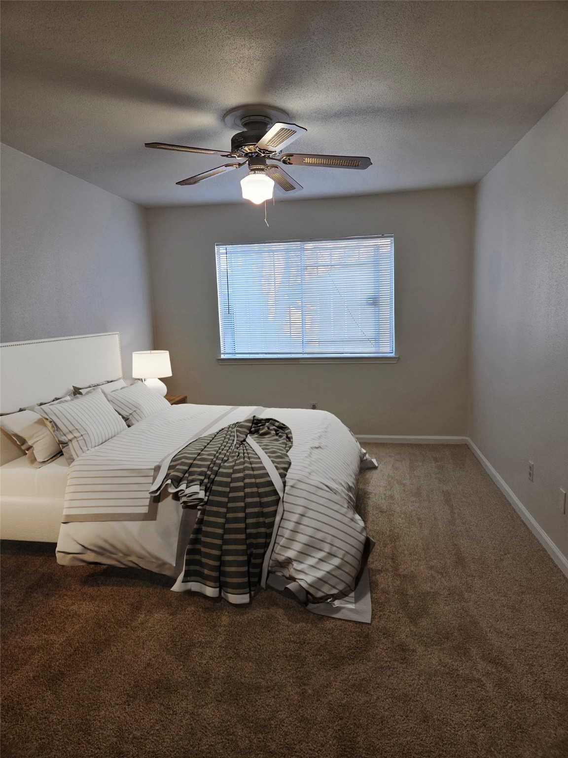12319 Ridgeside Drive Houston, TX 77072 - Photo 12 of 22 a bedroom with a bed and ceiling fan