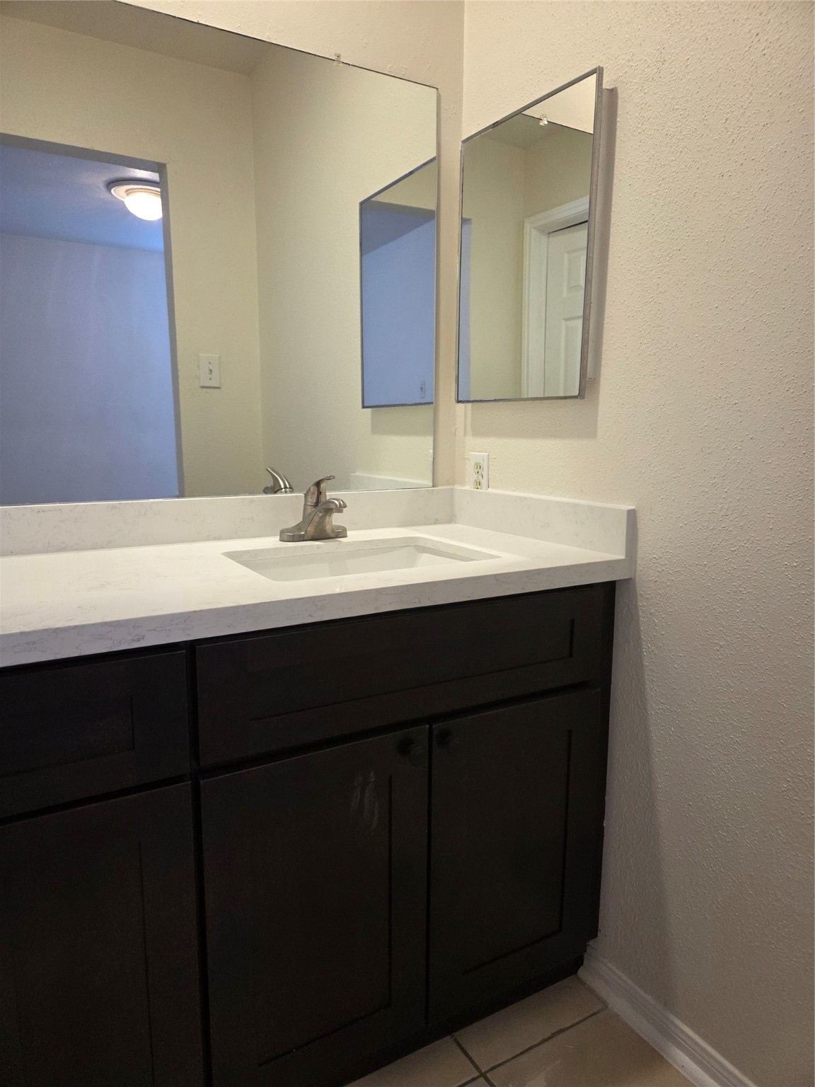 12319 Ridgeside Drive Houston, TX 77072 - Photo 17 of 22 a bathroom with a double vanity sink and a mirror