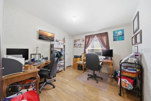 12148 Rutherford Lane Hudson, FL 34669 - Photo 14 of 30 a view of a workspace with furniture and a window