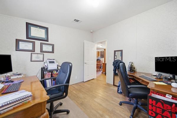 12148 Rutherford Lane Hudson, FL 34669 - Photo 15 of 30 a view of a workspace with furniture and a window