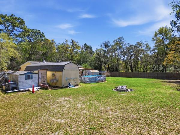 12148 Rutherford Lane Hudson, FL 34669 - Photo 22 of 30 a front view of a house with garden