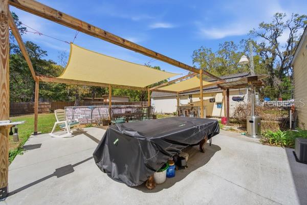 12148 Rutherford Lane Hudson, FL 34669 - Photo 26 of 30 a view of a patio with a table and chairs