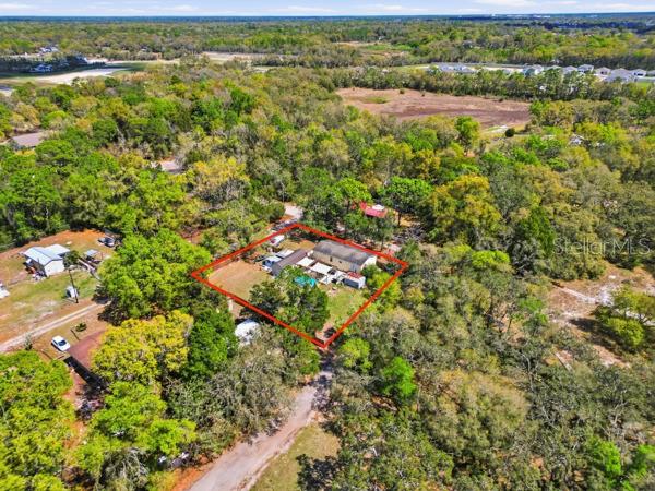 12148 Rutherford Lane Hudson, FL 34669 - Photo 27 of 30 an aerial view of residential houses with outdoor space and trees