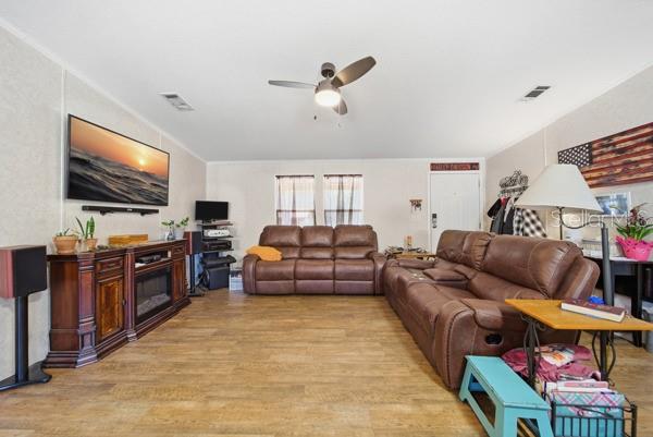12148 Rutherford Lane Hudson, FL 34669 - Photo 5 of 30 a living room with furniture and a flat screen tv