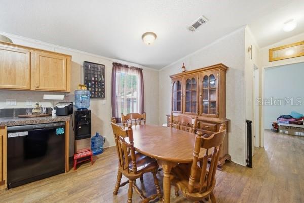 12148 Rutherford Lane Hudson, FL 34669 - Photo 10 of 30 a view of a dining room with furniture and wooden floor