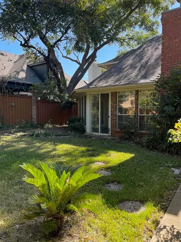 a view of a house with swimming pool and a yard with chairs