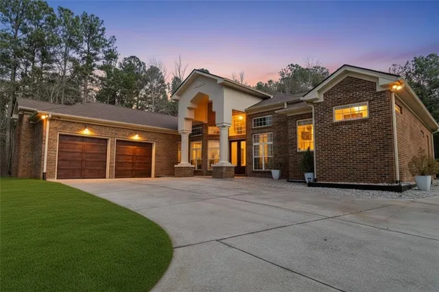 a front view of a house with a yard and garage